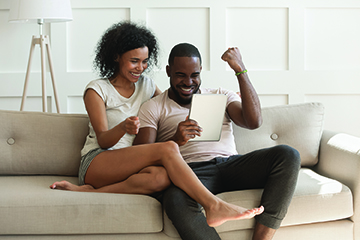 Couple playing game on tablet